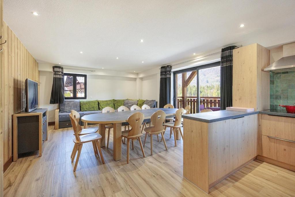 une cuisine et un salon avec une table et des chaises dans l'établissement Carline, à Morillon