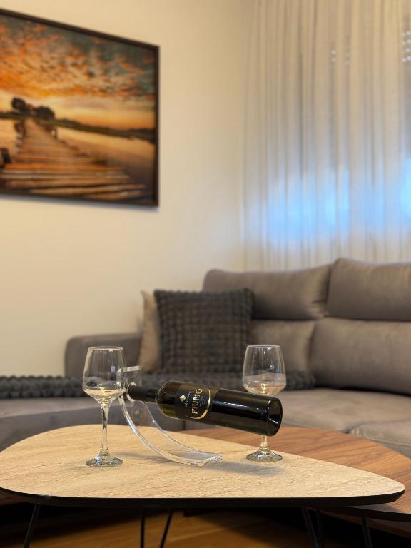 two glasses of wine on a table in a living room at Luxury apartment Gabi 1 in Slavonski Brod
