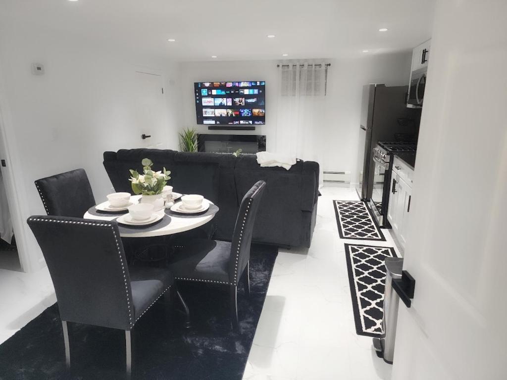 a living room with a table and chairs and a couch at Baldwin, NY 1 Bedroom Apartment Queen Size Bed in Baldwin