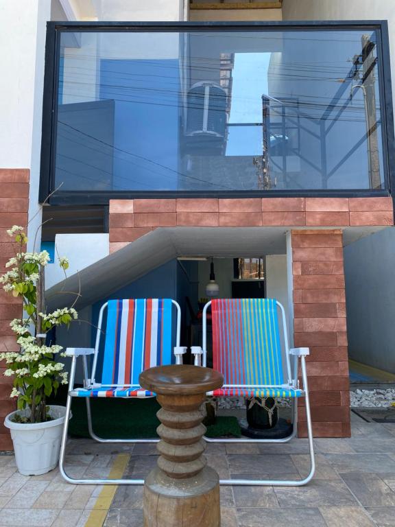 two chairs and a table on a patio at Mar&Brisa Hospedagem in Penha
