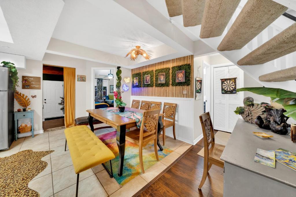 a kitchen and dining room with a table and chairs at Zen Jungle House by Busch Gardens Sleeps 12 with Outdoor Games & Detached Play Space! in Tampa