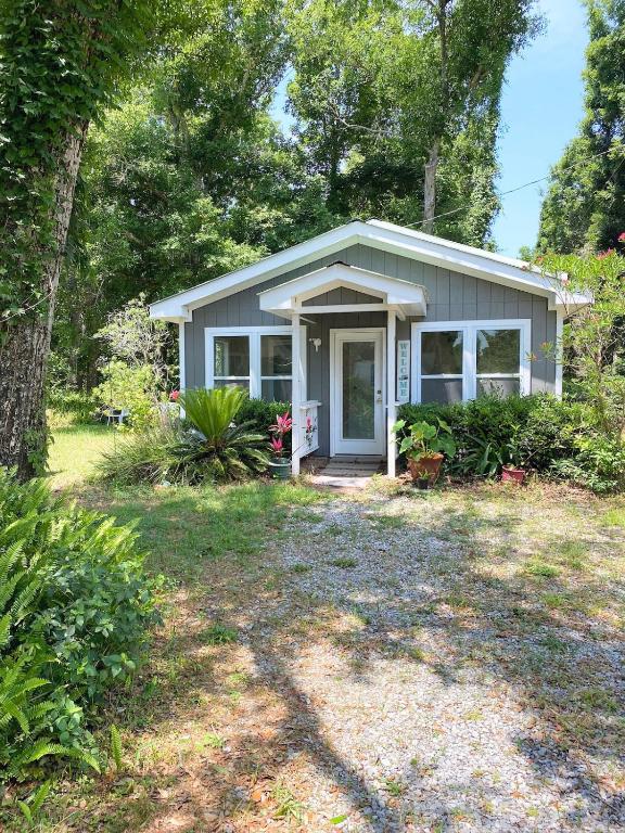 a small house with a porch and a yard at Studio-Bay access-Pet friendly in Gulf Shores