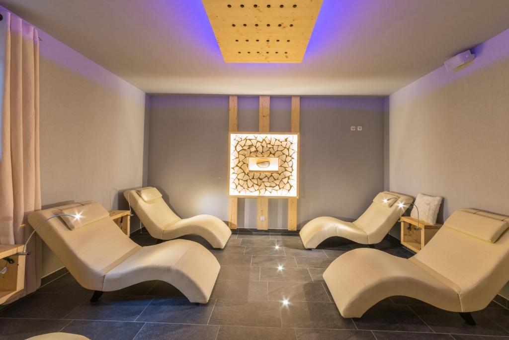 a waiting room with white chairs and a window at Hotel Waldhof in Hohenkammer