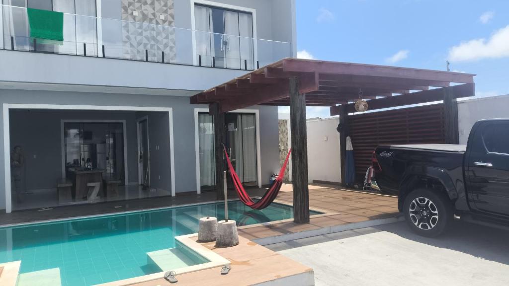 a truck parked in front of a house with a hammock at salinopolis atalaia in Salinópolis