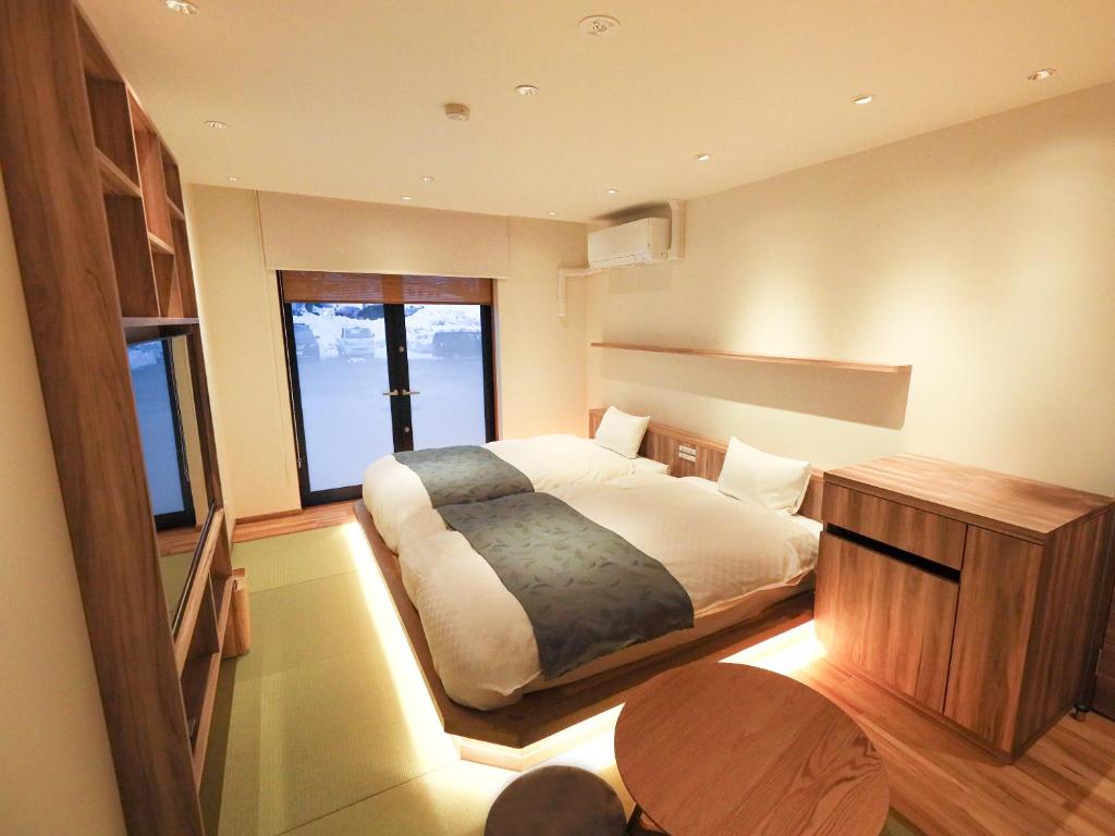 Postel nebo postele na pokoji v ubytování Hakuba Ryujin Onsen RYOKAN SUI