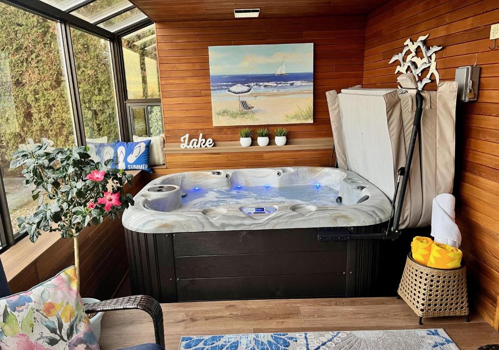 a jacuzzi tub in the corner of a room at Lake and the City Bed and Breakfast in West Kelowna