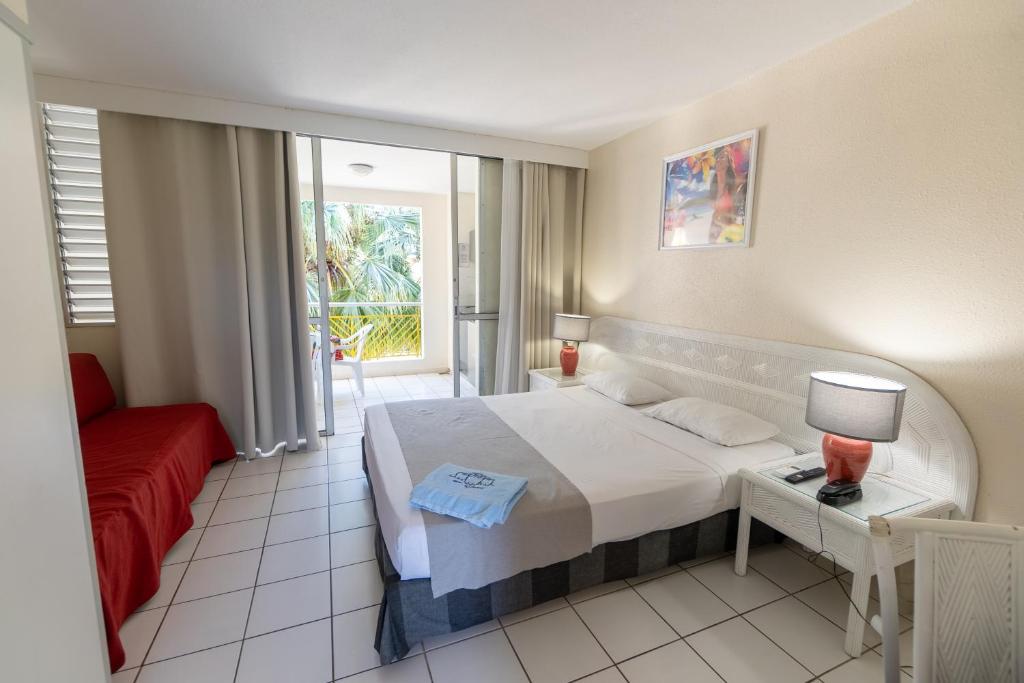 Uma cama ou camas num quarto em Canella Beach Hotel