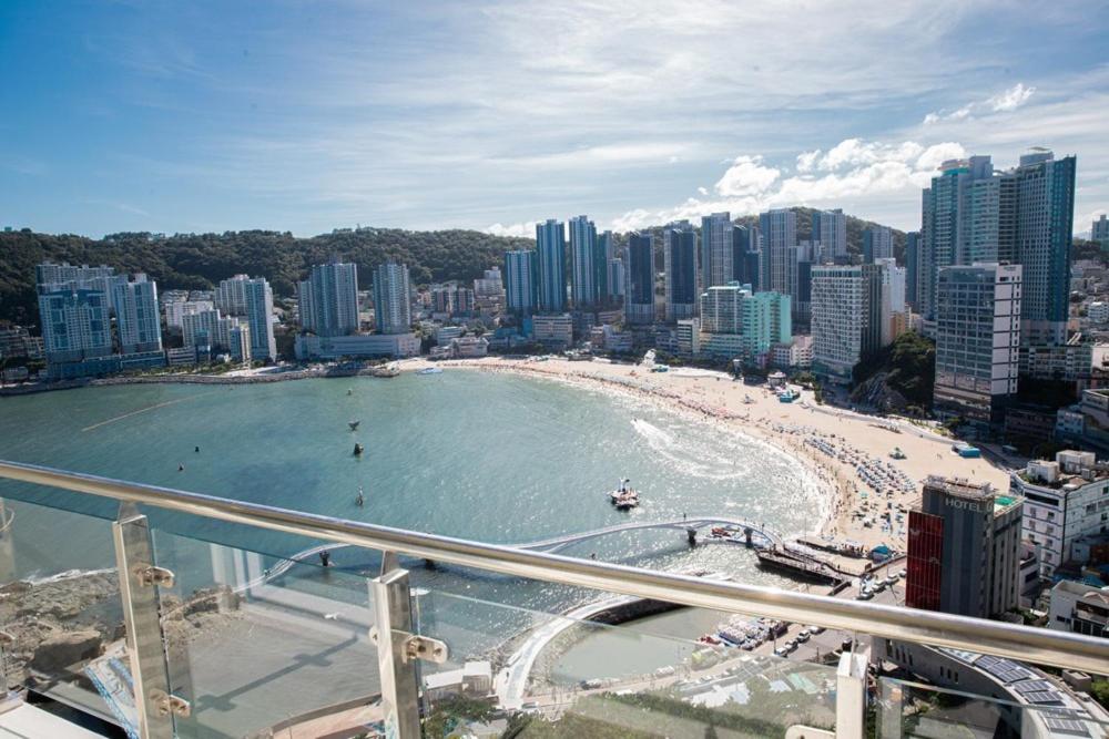 a view of a beach and a city with buildings at Busan Ocean Sky Osilla in Busan