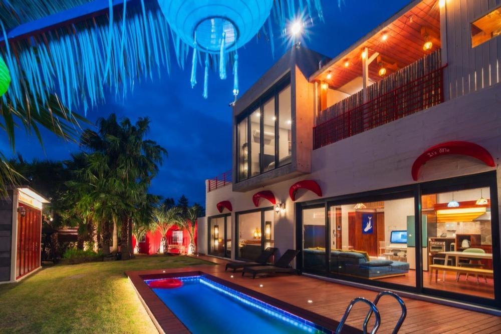 a house with a swimming pool in front of it at Its you Pool Villa in Jeju
