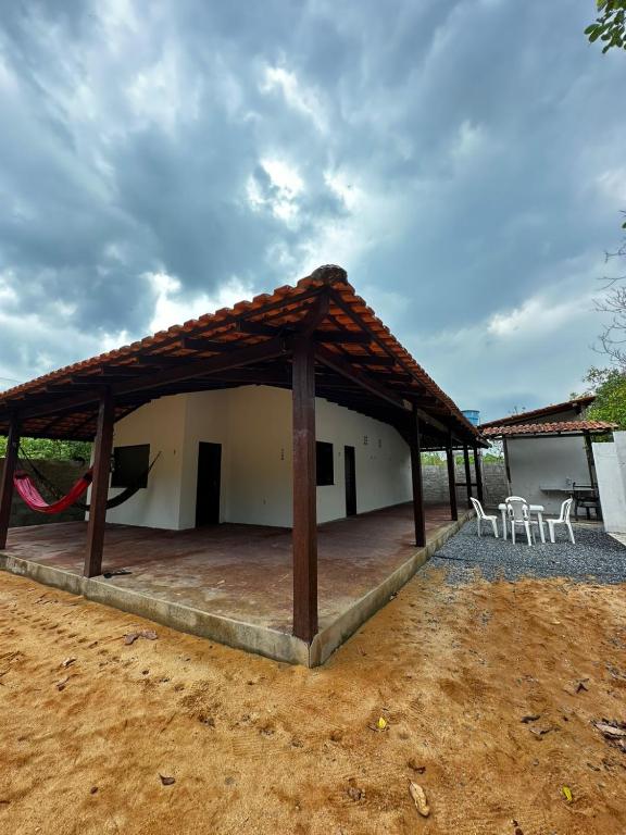 a building with a pavilion with tables and chairs at Casa com 3 quartos em Alter do Chão in Santarém