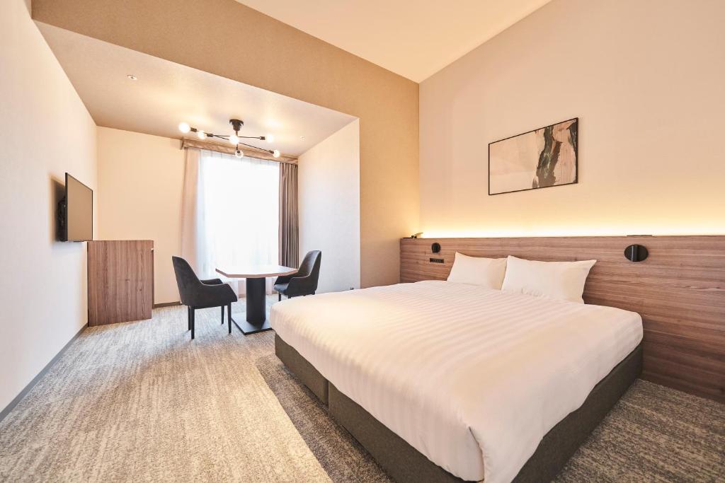 Postel nebo postele na pokoji v ubytování Hotel Grand Tiara Minaminagoya