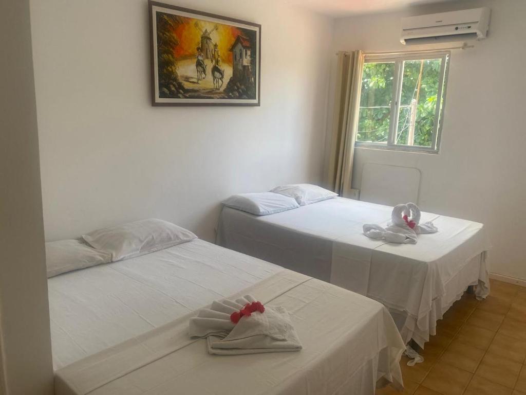 Ένα ή περισσότερα κρεβάτια σε δωμάτιο στο Suites Porto Dos Milagres