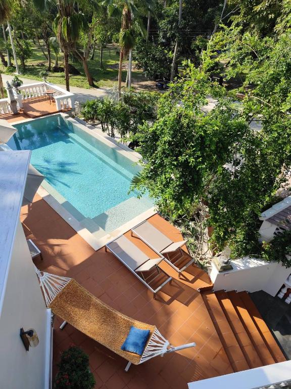 an overhead view of a swimming pool with lounge chairs and a swimming pool at O - HO Boutique Home in Ban Tai