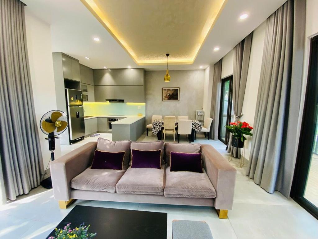 a living room with a couch and a table at Swanbay - Hà Hoàng Villa in Cù Lao Ong Con