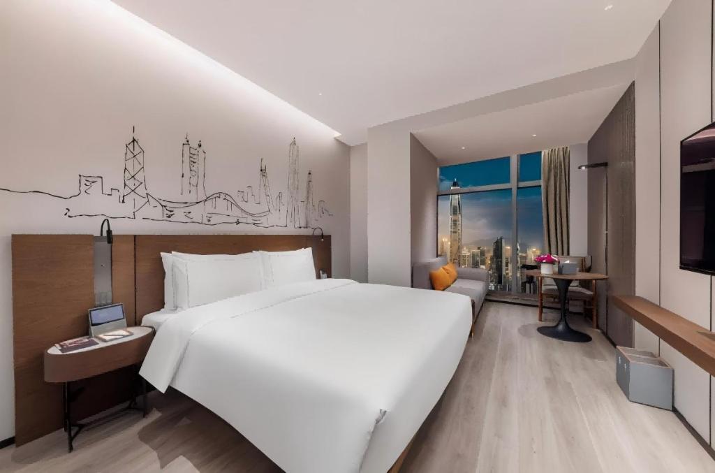 Postel nebo postele na pokoji v ubytování UrCove By Hyatt ShenZhen Futian Port毗邻中洲湾C Future City 福田口岸 尊享免费迷你吧