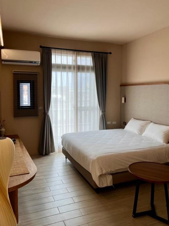 Postel nebo postele na pokoji v ubytování Yuzhi Wenlv B&B