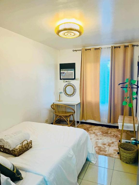 a bedroom with a bed and a table and a mirror at Eclectic Haven at Urban Deca Homes - 2 bedroom micro unit near SM City , IT Park & Ayala Mall - N0 PARKING in Mandaue City