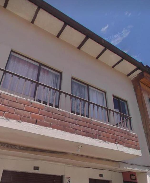 a balcony on top of a brick building at San Roque Dpto in Cuenca