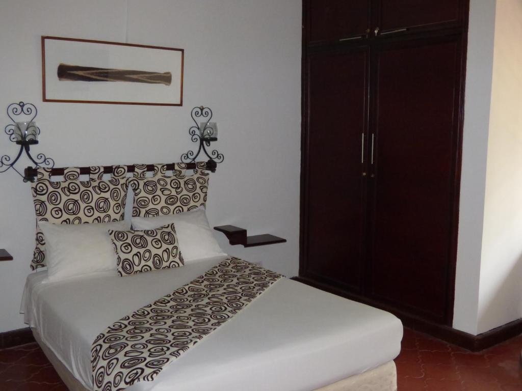 Postel nebo postele na pokoji v ubytování Hostal Mizare Valledupar