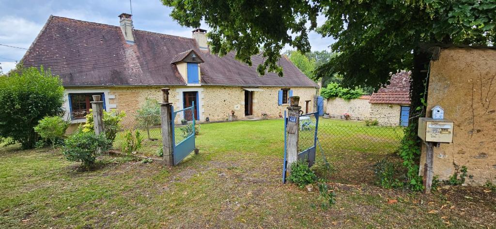 une vieille maison avec un portail devant elle dans l'établissement La Périgourdine, à Lacropte