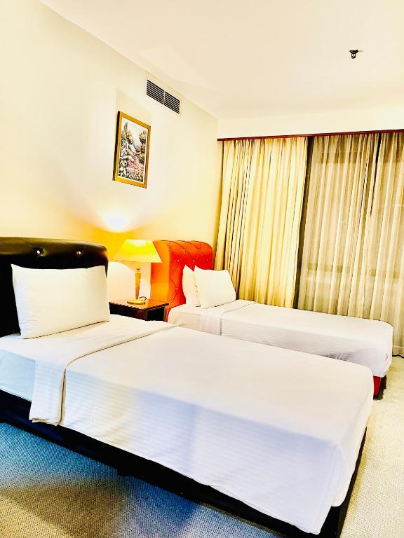 Postel nebo postele na pokoji v ubytování RESORT SUITES AT BARJAYA TIMES SQUARE kL