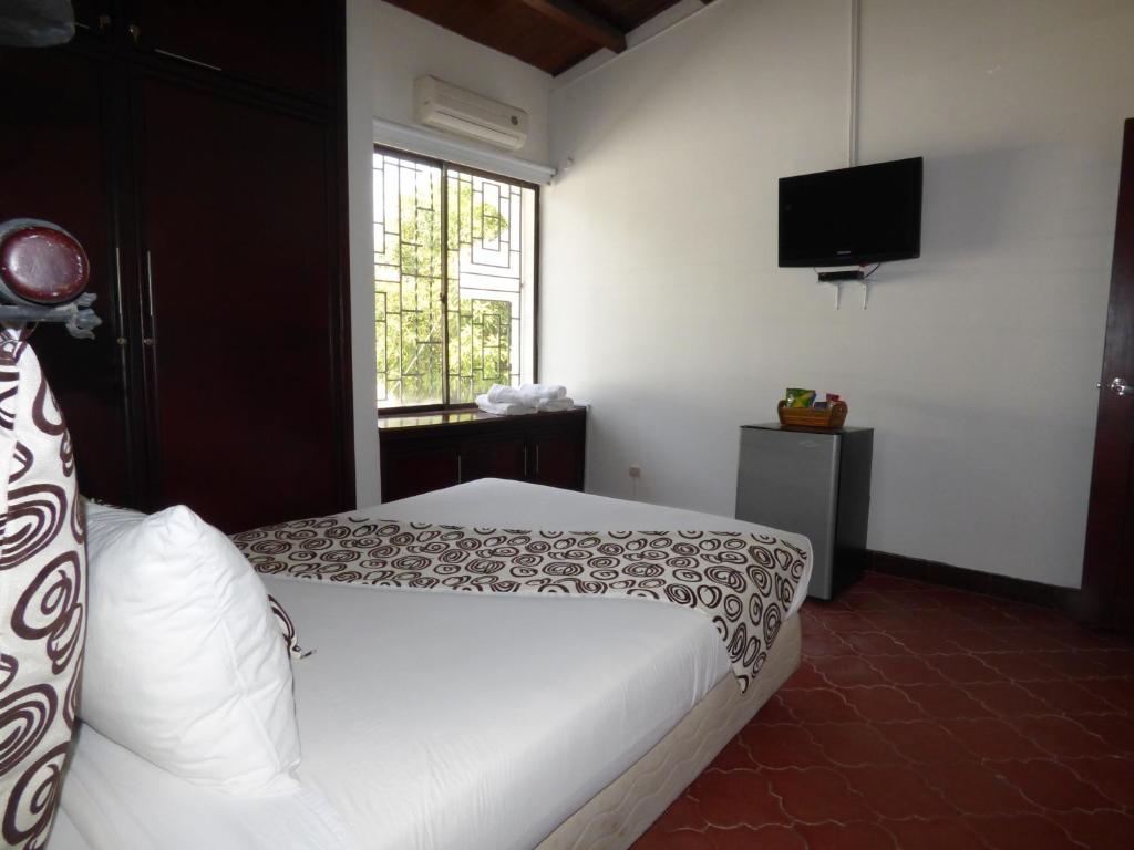 Postel nebo postele na pokoji v ubytování Hostal Mizare Valledupar
