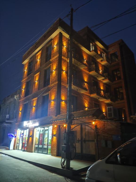 a tall building with lights on the side of it at Tsalamuri Old Tbilisi in Tbilisi City
