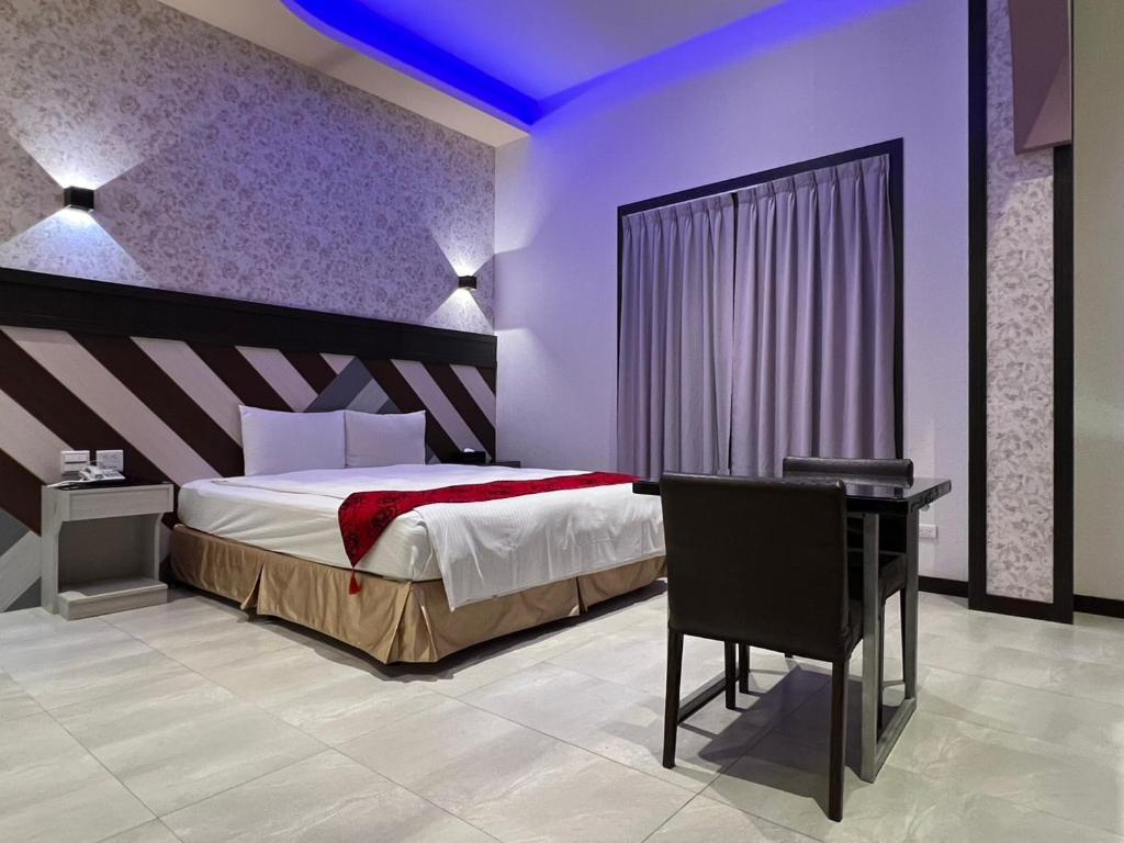 Postel nebo postele na pokoji v ubytování Wei Feng Exquisite Motel Pintung Branch