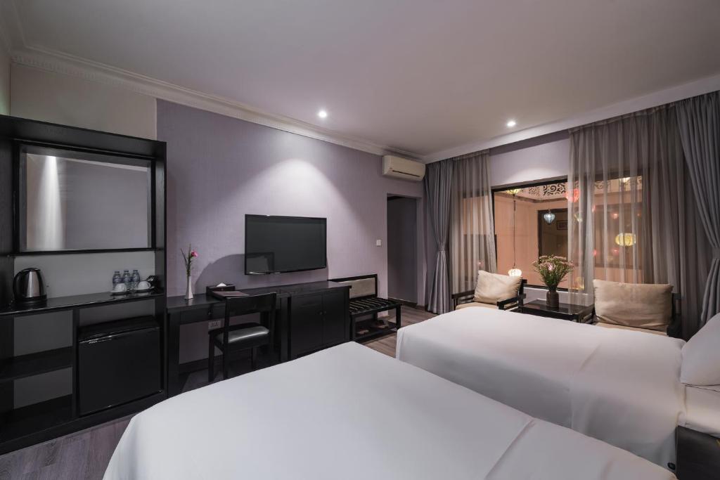 Postel nebo postele na pokoji v ubytování La Passion Classic Hotel