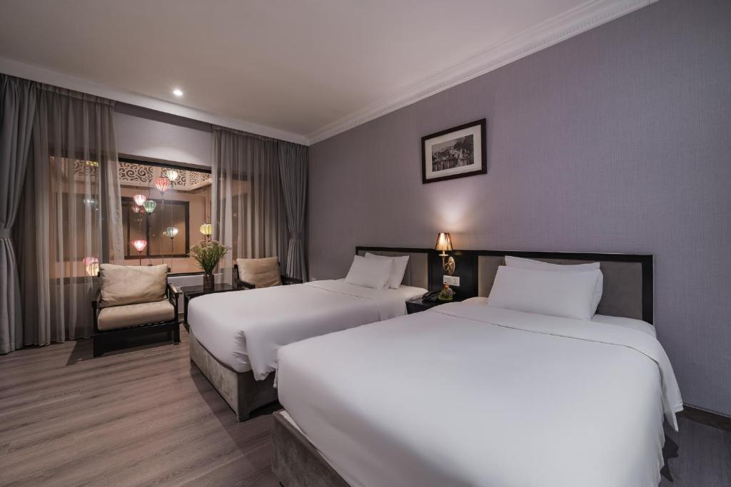 Postel nebo postele na pokoji v ubytování La Passion Classic Hotel
