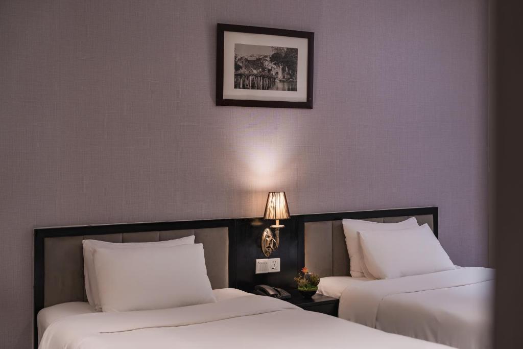 Postel nebo postele na pokoji v ubytování La Passion Classic Hotel