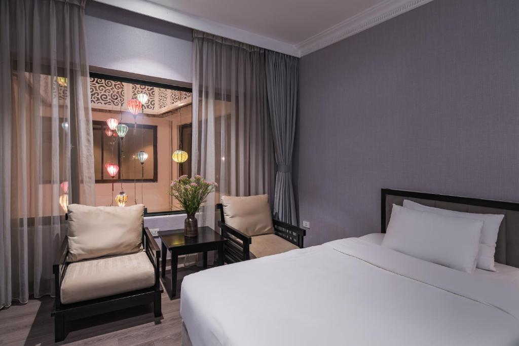 Postel nebo postele na pokoji v ubytování La Passion Classic Hotel