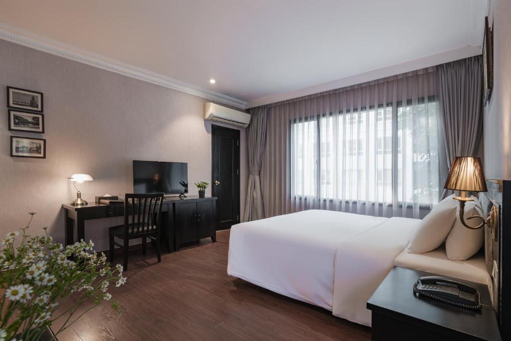 Postel nebo postele na pokoji v ubytování La Passion Classic Hotel