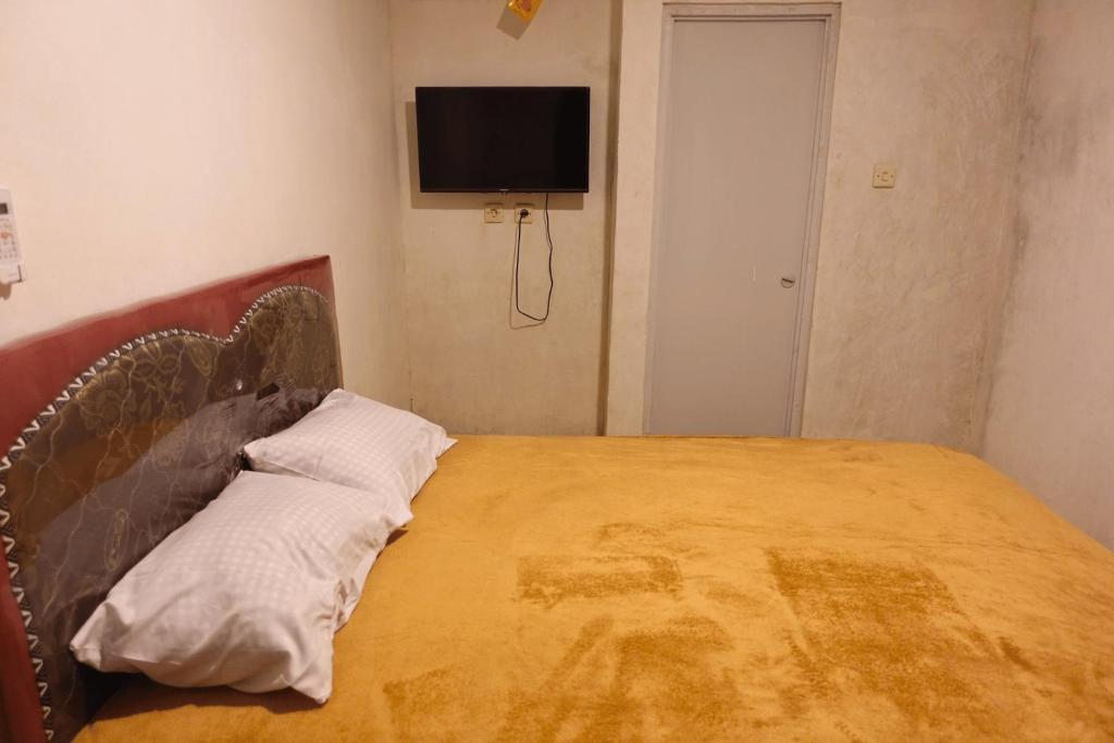Postel nebo postele na pokoji v ubytování Mayeka Transit Hostel Bandara Internasional Lombok
