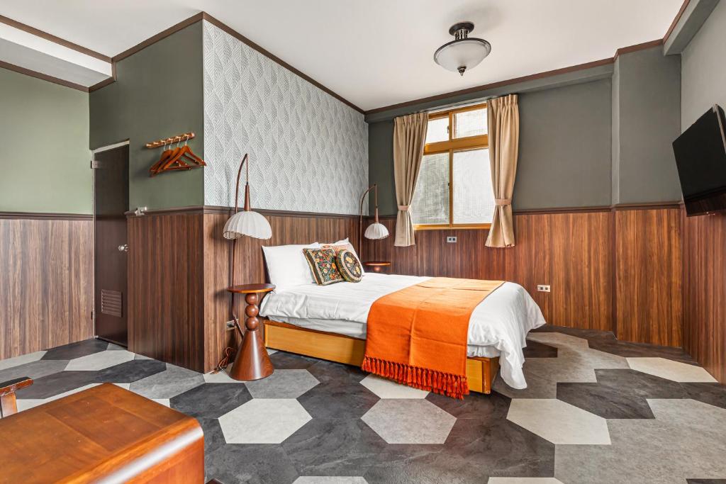 Postel nebo postele na pokoji v ubytování Jiufen Nostalgic Inn