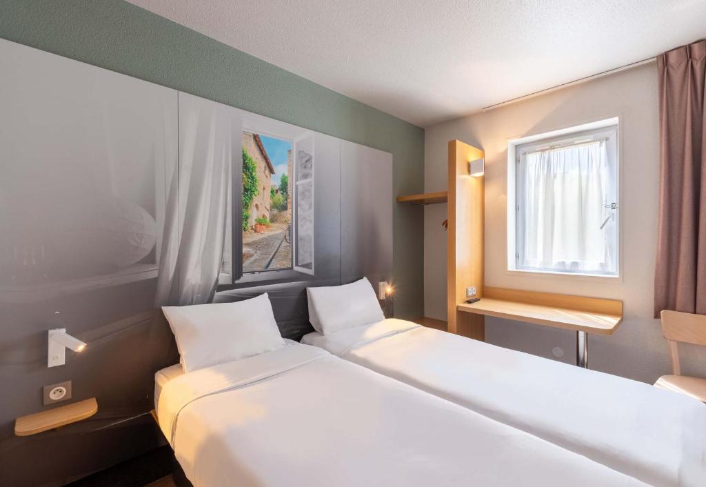 Postel nebo postele na pokoji v ubytování B&B HOTEL Montélimar Nord