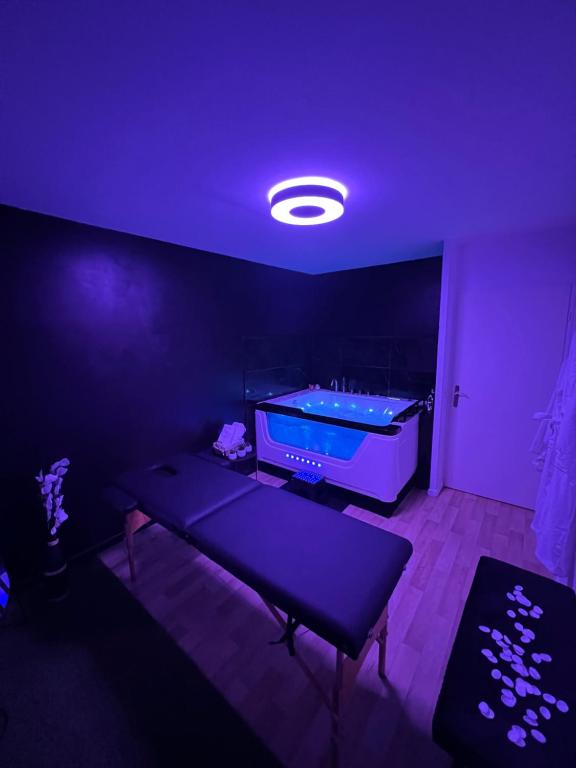 a room with a pool table in a dark room at L’escapade Paris spa in Vauréal