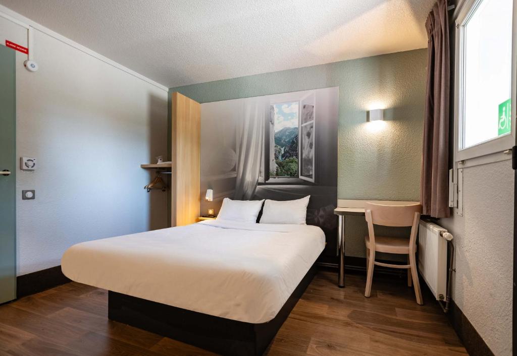 Postel nebo postele na pokoji v ubytování B&B HOTEL Valence Nord