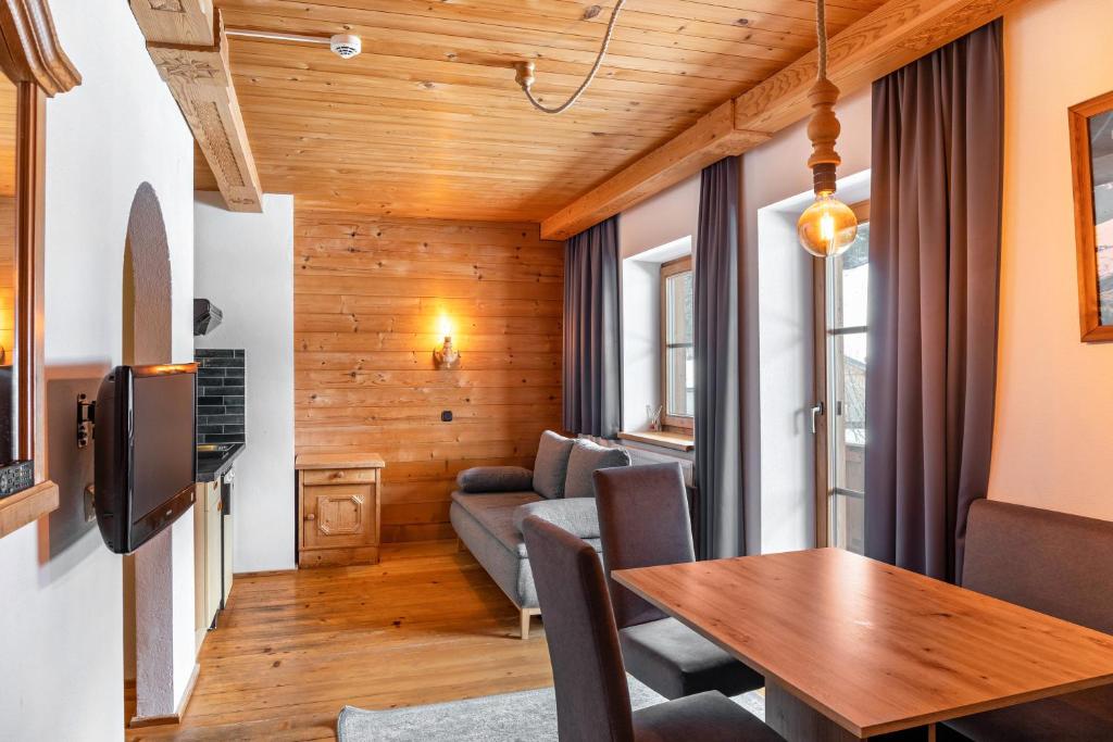 a living room with a table and a couch at Schwüwong - Apartment 23 in Kelchsau