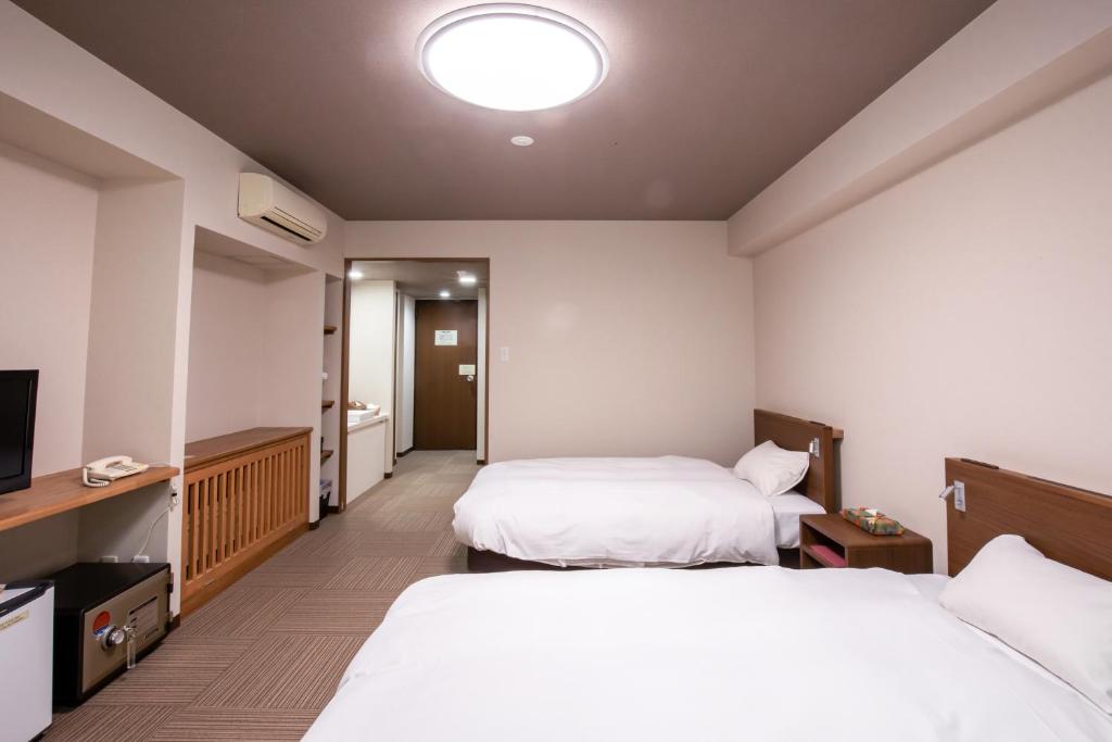 Postel nebo postele na pokoji v ubytování Hotel Umenoyu