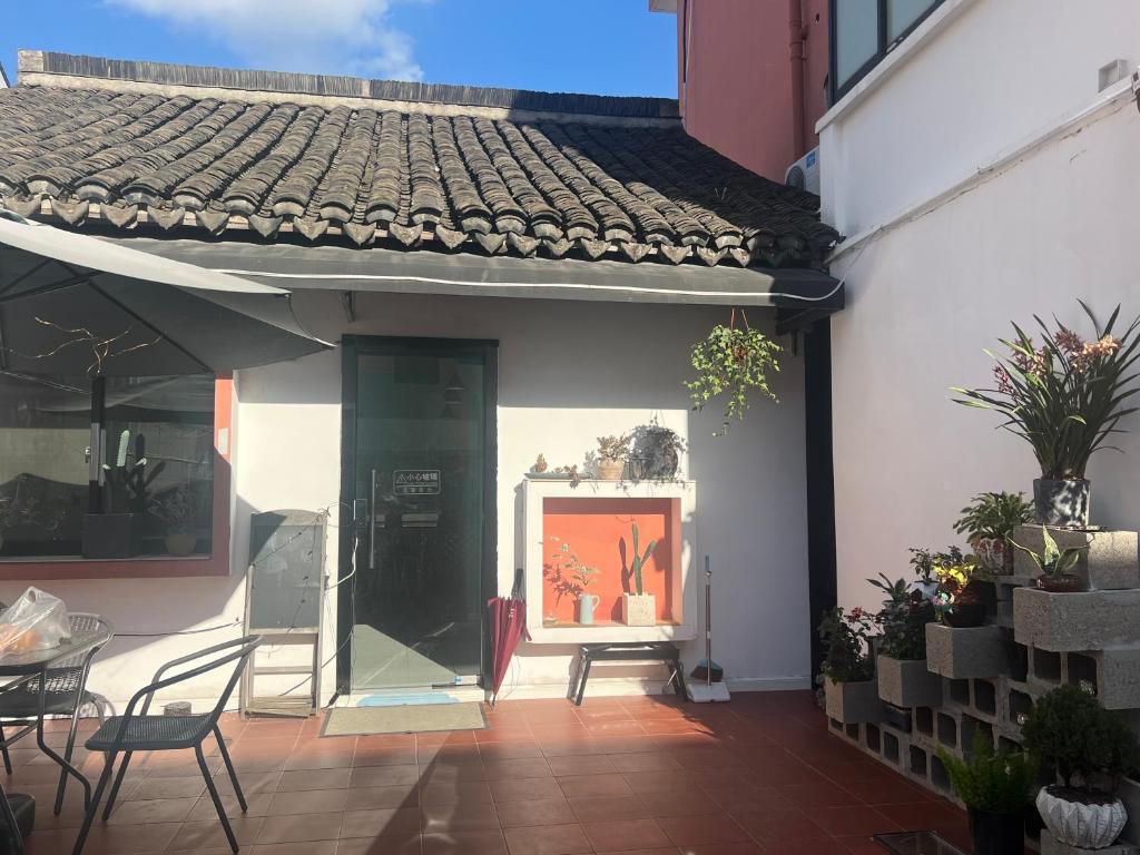 a patio with a painting on the side of a building at Shanghai Guiwu Village Near Disney Resort in Shanghai