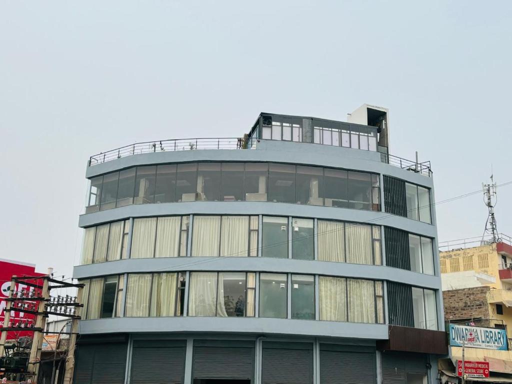 a tall blue building with glass windows at Hotel Runway Inn in Jodhpur