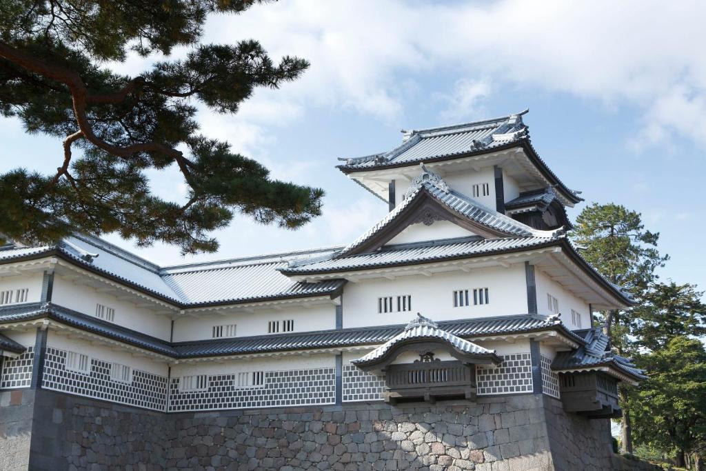 an imperial palace with a tall building at HOTEL MYSTAYS PREMIER Kanazawa in Kanazawa