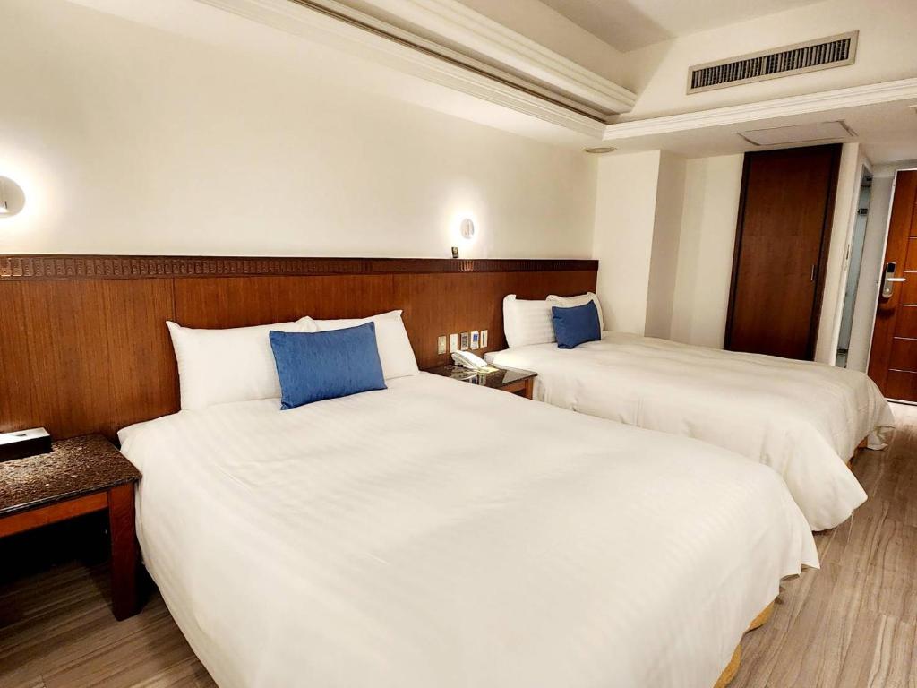 Postel nebo postele na pokoji v ubytování Hub Hotel Kaohsiung Cisian Branch