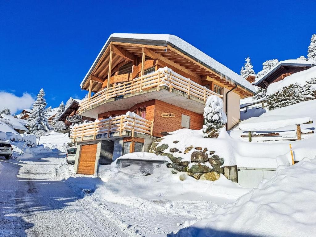 a log cabin in the winter with snow on the ground at Holiday Home Midat soleil by Interhome in Verbier