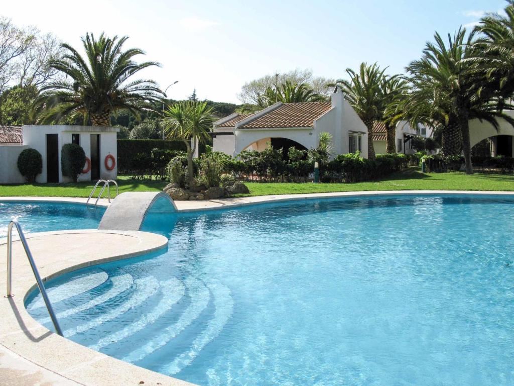 a large swimming pool in front of a house at Holiday Home Ducados Golf by Interhome in Pals