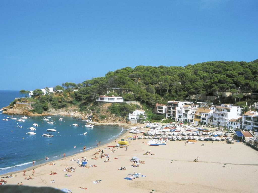 a group of people on a beach with the ocean at Apartment S'Esquirol Nº9 by Interhome in Begur