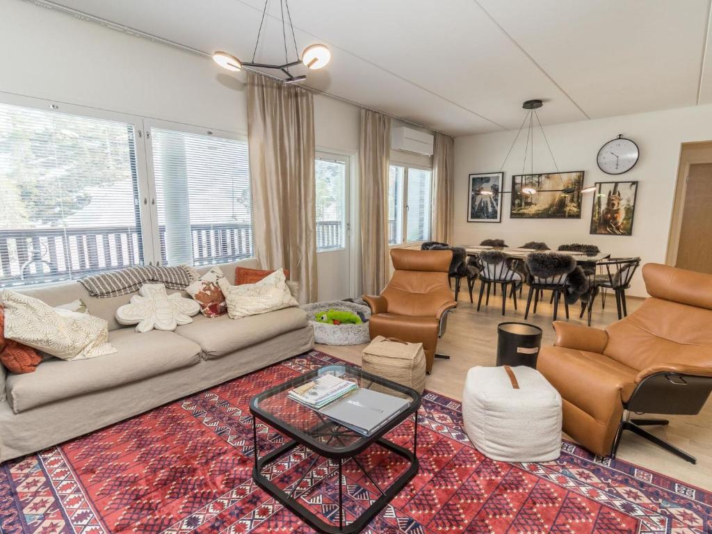 ein Wohnzimmer mit Sofa, Stühlen und einem Tisch in der Unterkunft Holiday Home Casa krogerus ruka by Interhome in Rukatunturi 
