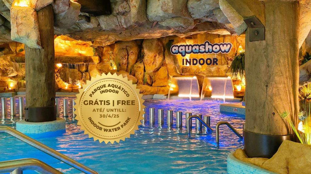 a water park with a swimming pool in a theme park at Aquashow Park Hotel in Quarteira