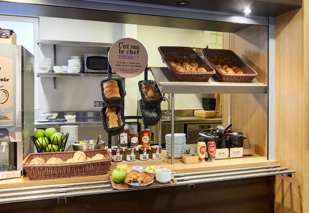 a bakery display case with bread and pastries at B&B HOTEL Paris Le Bourget in Le Bourget